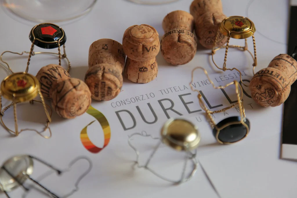 Tappi e gabbiette di spumante sul logo del Consorzio Tutela Vini Lessini Durello